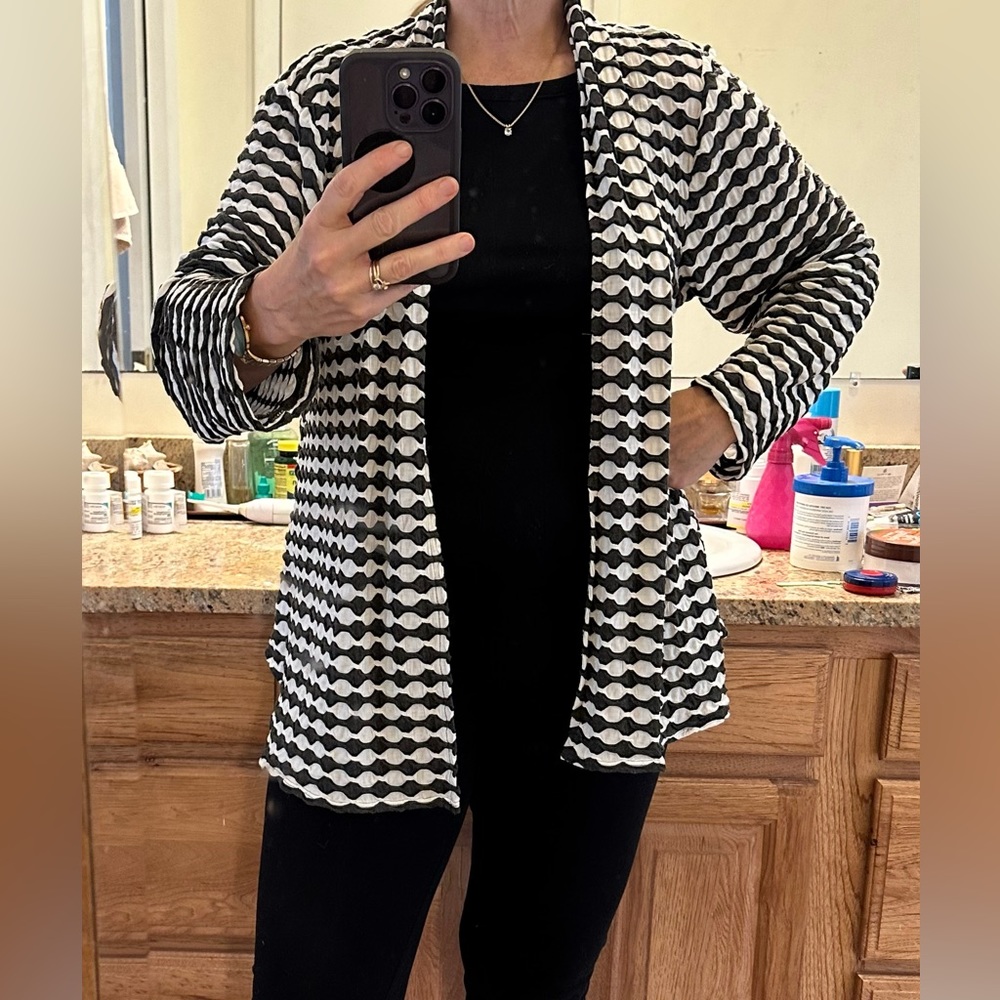 Black and white patterned cardigan.